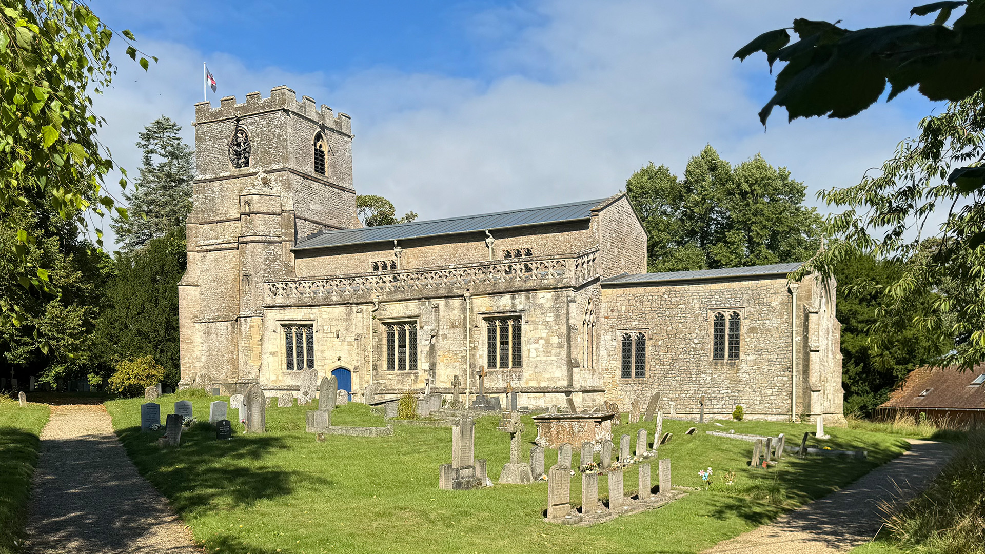 St Mary’s Church Bishopstone exterior with tower churchyard and village setting Wiltshire
