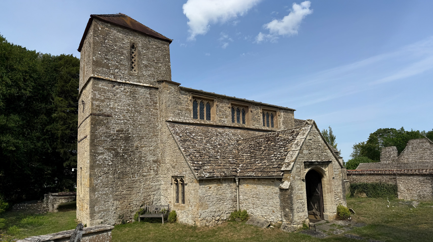 St Swithun's Church Lyddington Rutland exterior stone church with porch and tower